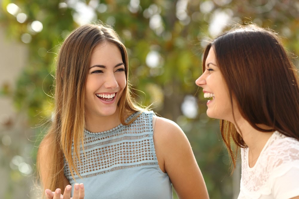 two women talking and laughing