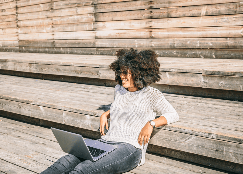 woman sunglasses wooden steps laptop
