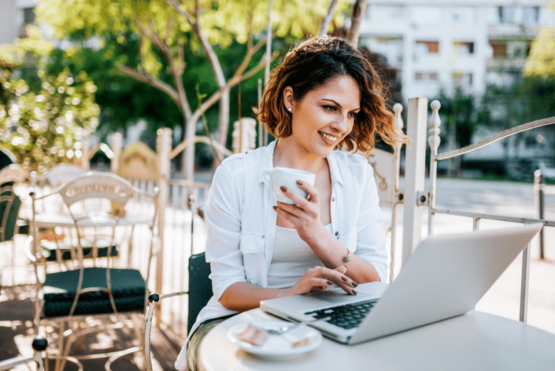 woman working on laptop outdoor cafe