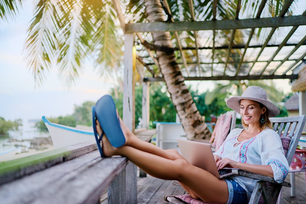 woman laptop deck outside feet up